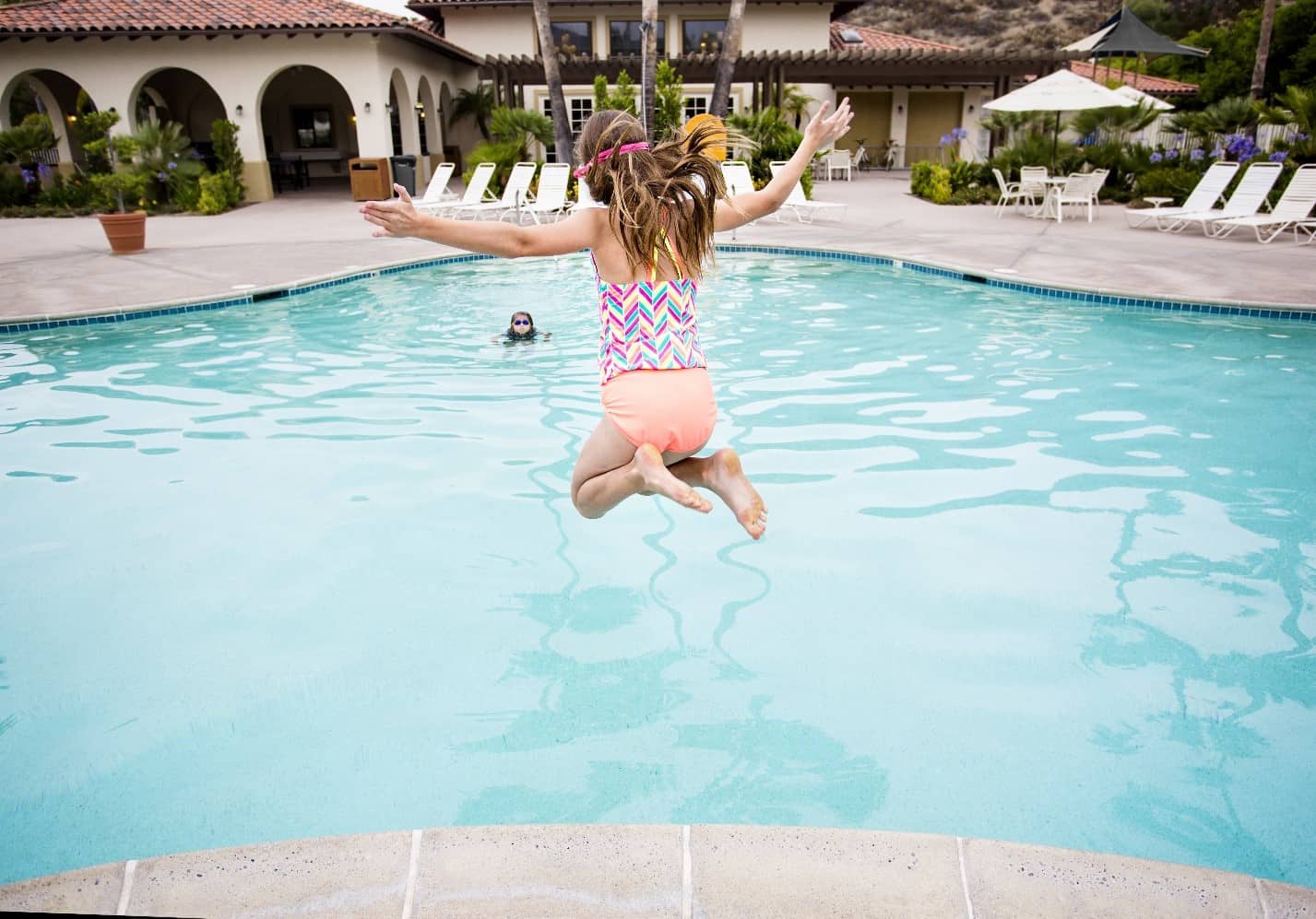 girl-jumping-into-pool