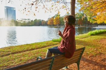 woman enjoying fall in Texas by a lake